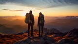 man and woman tourist hiking at mountain peak at sunset, romantic hikers couple standing at cliff at sunrise
