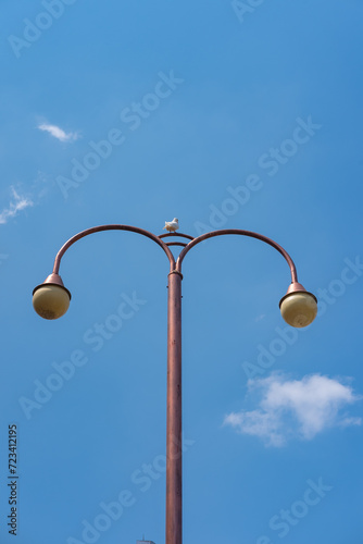 Lamp post isolated on blue sky, taken on broad daylight.
