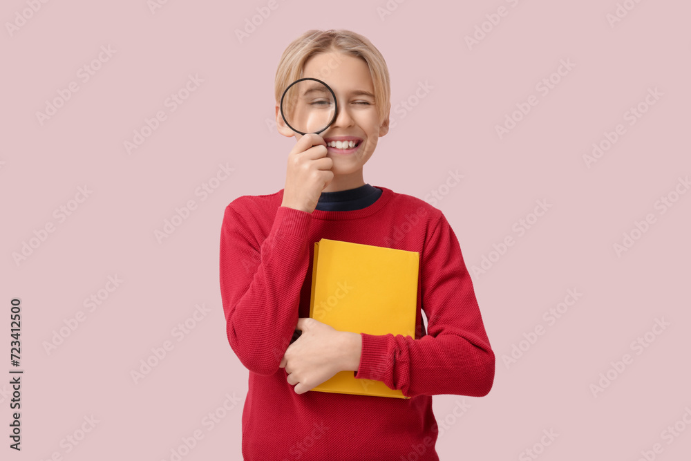 Cute little boy with book and magnifier on pink background Cute little boy with book and magnifier on pink background