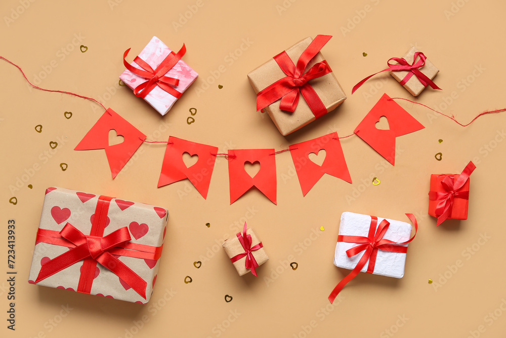 Gift boxes and garland made of paper flags on brown background. Valentine's Day celebration Gift boxes and garland made of paper flags on brown background. Valentine's Day celebration