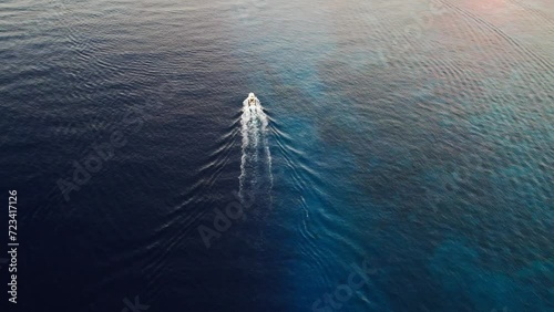 Yacht in cozumel ocean. Aerial view of a boat crossing the blue waves of the caribbean ocean photo