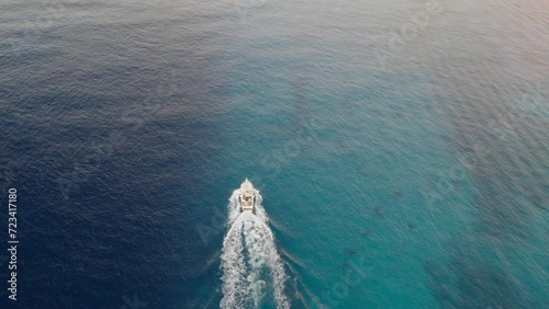 Yacht in cozumel ocean. Aerial view of a boat crossing the blue waves of the caribbean ocean photo