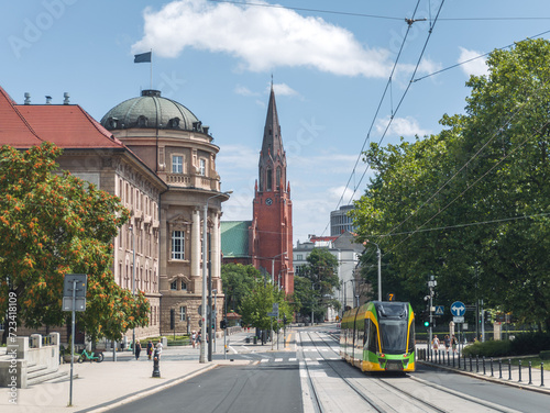 Green cityscape of Poznan, Wielkopolska, Poland: tram on Fredry street with landmarks around, on a calm sunny summer day