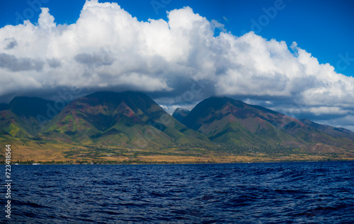 Photo of Maui, Hawaii from the ocean. Lahaina before the fire. Clouds forming over Maui Island