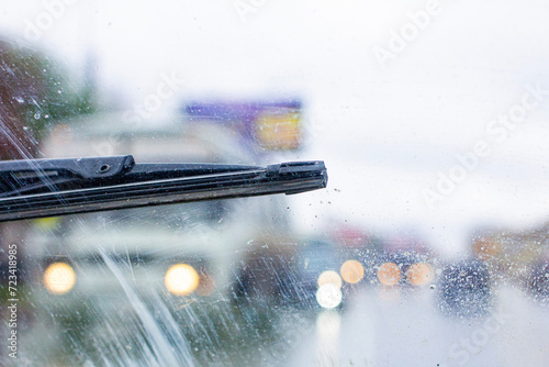 Fototapeta Naklejka Na Ścianę i Meble -  Windshield wipers from inside of car, season rain. The problem of poor road visibility and traffic hazards on the road