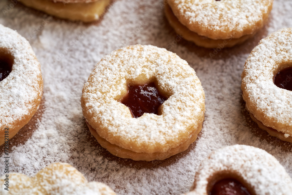 Linzer Christmas cookies filled with strawberry marmalade and dusted with sugar