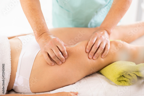 Working-out of female problem areas at anti-cellulite massage session