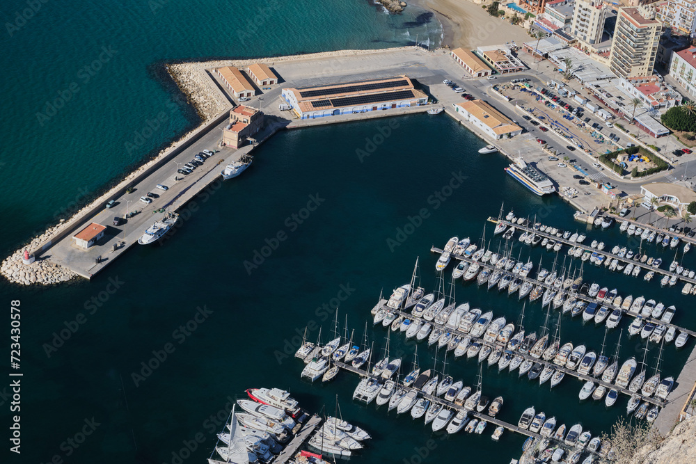 Aerial view of port in Calpe town. Port full of yachts and a view of the pier.

Calp, Alicante, Spain