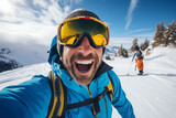 Happy skier in blue winter clothes taking selfie with his smartphone. Concept of young man having fun in weekend activity at vacation ski resort.
