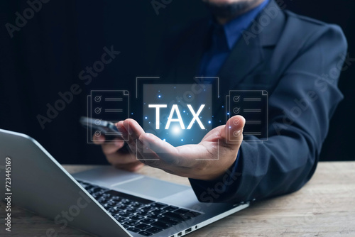 E-tax Tax payment, TAX online payment and technology concept. Businessman using the laptop to fill in the income tax online return form for payment. Financial research, taxes calculation tax return.