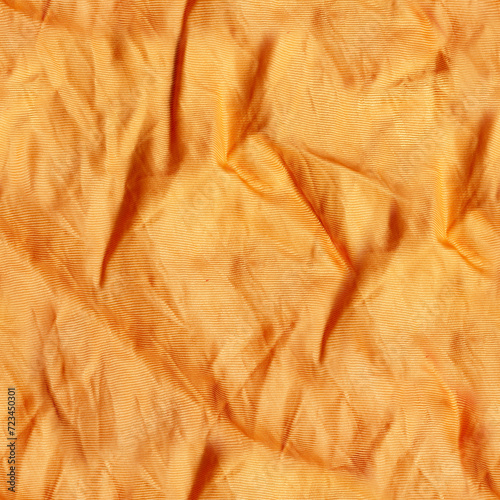 Seamless texture photo of orange colored wrinkled silk drapery material.