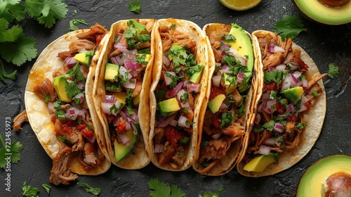 mexican street tacos flat lay composition with pork carnitas, avocado, onion, cilantro