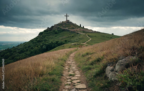 Holy cross symbolizing the death and resurrection of Jesus Christ with The sky over Golgotha Hill is shrouded in light and clouds	
 photo