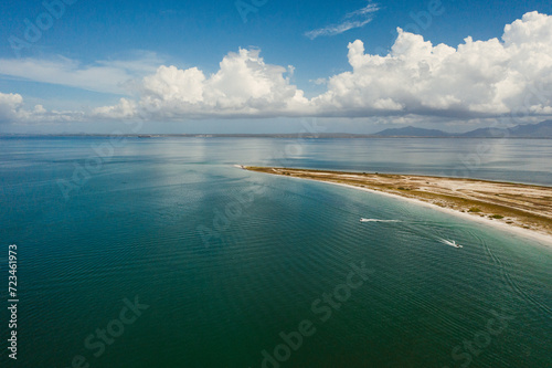 Vista aérea de orilla de playa en el caribe bajo el cielo azul y grandes nubes blancas
