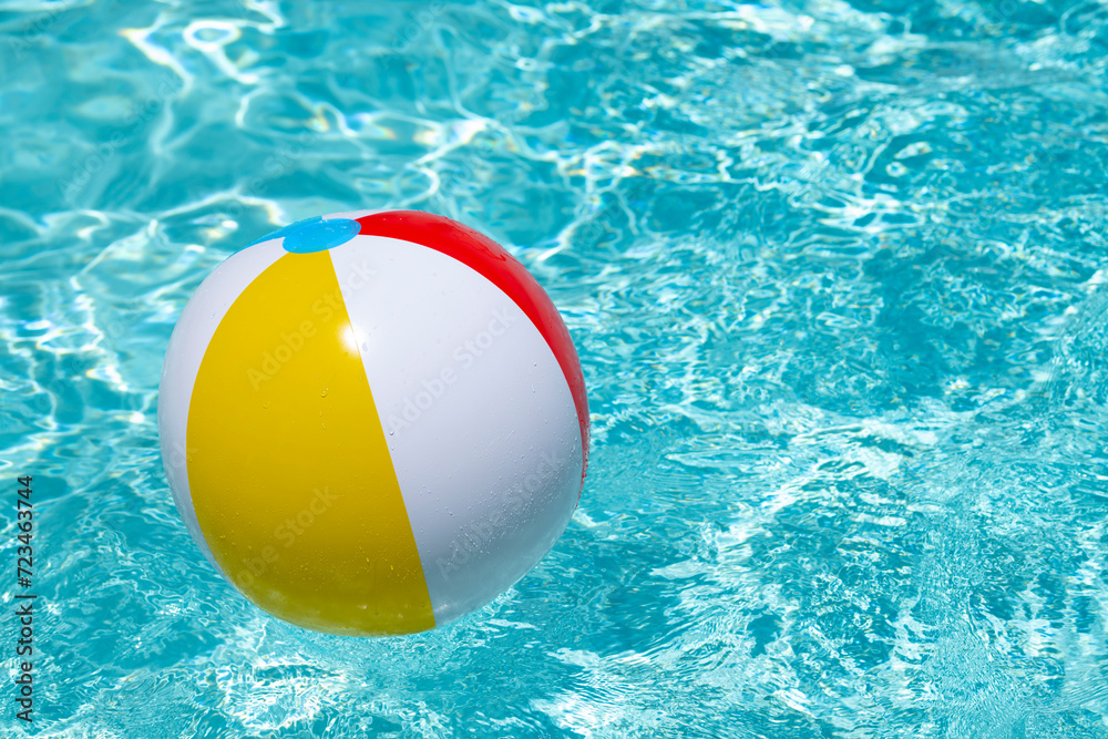 Summer vacation. Beach ball. Summer party. Inflatable beach ball. Striped ball for play in water. Copy space for text.