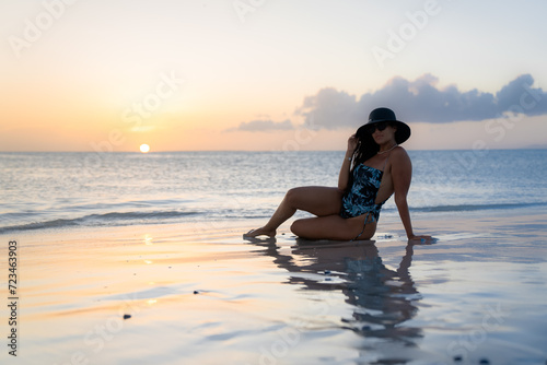 Mujer latina en hermosa playa de Venezuela junto al atardecer  photo