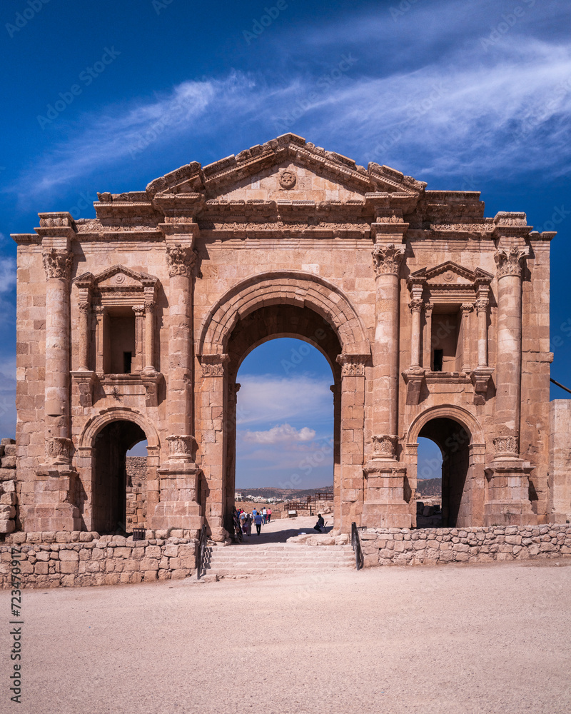 Jerash, Jordan November 9 2022: The largest roman city remaining. Hadrians gate marks the entrance to the city with deep blue sky and sunny weather