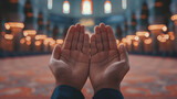 Close up hands Open up Palm Praying During Month of Ramadan, isolated at blurred mosque as background.
