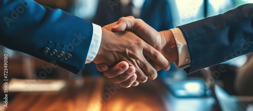 Business individuals exchange handshakes during the signing of a business contract agreement.