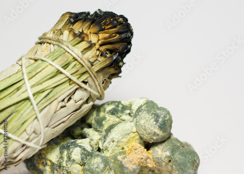 California White Sage and Sweetgrass Ceremonial Herb Bundle Resting on Rough Natural Formation of Green Prehnite Crystal Gemstone Mineral Healing Energy Crystal Cleansing Spiritual 