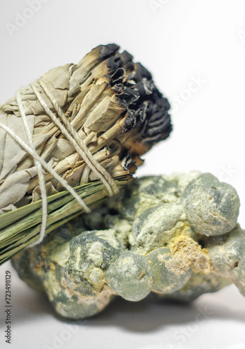 California White Sage and Sweetgrass Ceremonial Herb Bundle Resting on Rough Natural Formation of Green Prehnite Crystal Gemstone Mineral Healing Energy Crystal Cleansing Close Up