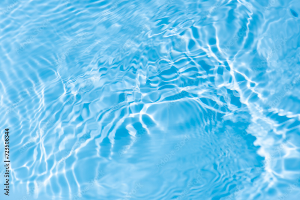 Water surface. Bluewater waves on the surface ripples blurred. Defocus blurred transparent blue colored clear calm water surface texture with splash and bubbles. Water waves with shining pattern. Water surface. Bluewater waves on the surface ripples blurred. Defocus blurred transparent blue colored clear calm water surface texture with splash and bubbles. Water waves with shining pattern.
