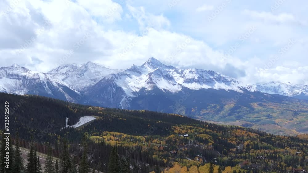 Majestic snowy mountain peak on horizon and fall landscape of Rocky Mountains, Colorado. Aerial Majestic snowy mountain peak on horizon and fall landscape of Rocky Mountains, Colorado. Aerial