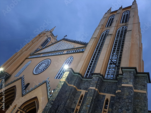 Parish of San Juan Bautista in front of the gardens of the plaza in the center of the magical town Xicotepec Puebla Mexico photo