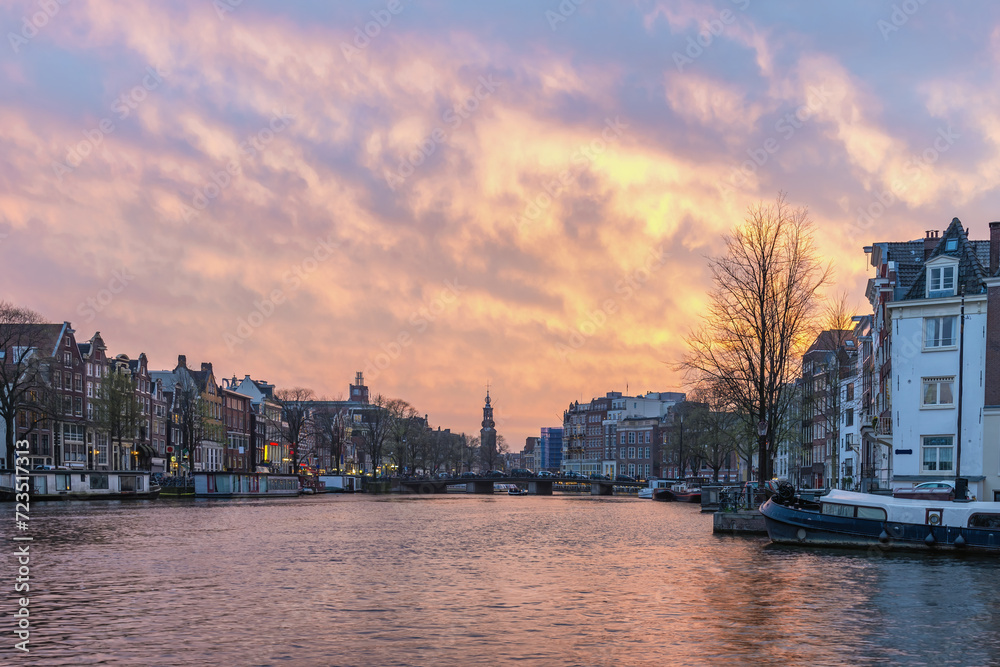 Amsterdam Netherlands, sunset city skyline of Dutch house at canal waterfront