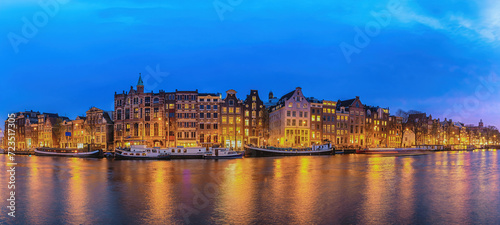 Amsterdam Netherlands, night panorama city skyline of Dutch house at canal waterfront