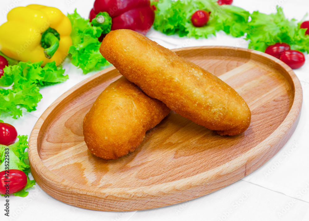 Fried mince pie, bun, pastry on a wooden board Fried mince pie, bun, pastry on a wooden board