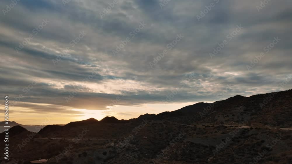 Heavy clouds passing over sea and hills at sunset Motion Lapse Heavy clouds passing over sea and hills at sunset Motion Lapse