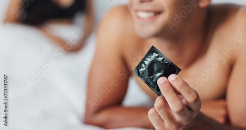 Man, condom and contraception for safety in bedroom, smile and proud for responsible choice at home. Couple, security and happy for protection with rubber and prevention of hiv and sexual illness