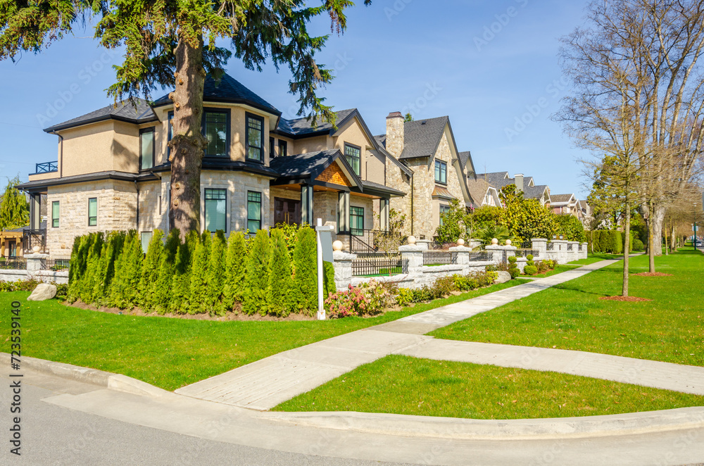 two story stucco luxury house with nice summer  landscape in Vancouver, Canada, North America.