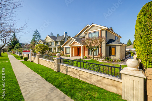 two story stucco luxury house with nice summer landscape in Vancouver, Canada, North America.