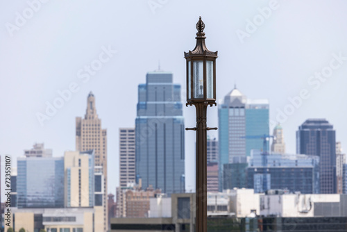 A historic street lamp frames a morning view of the downtown skyline of Kansas City, Missouri, USA.