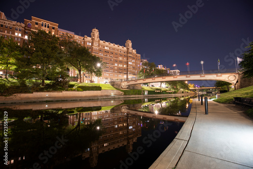 Night time view of the historic skyline along Brush Creek of Kansas City, Missouri, USA. photo