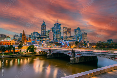 Melbourne Skyline behind Flinders Street Station and the Yarra River at Sunset. 