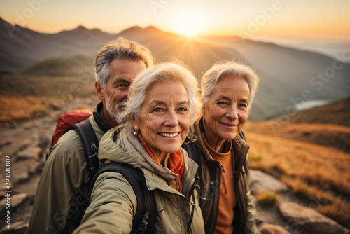 Group of senior middle-aged people looking at camera smiling spend free time trekking in the mountains. 
