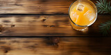 Iced orange juice in glass on wooden table