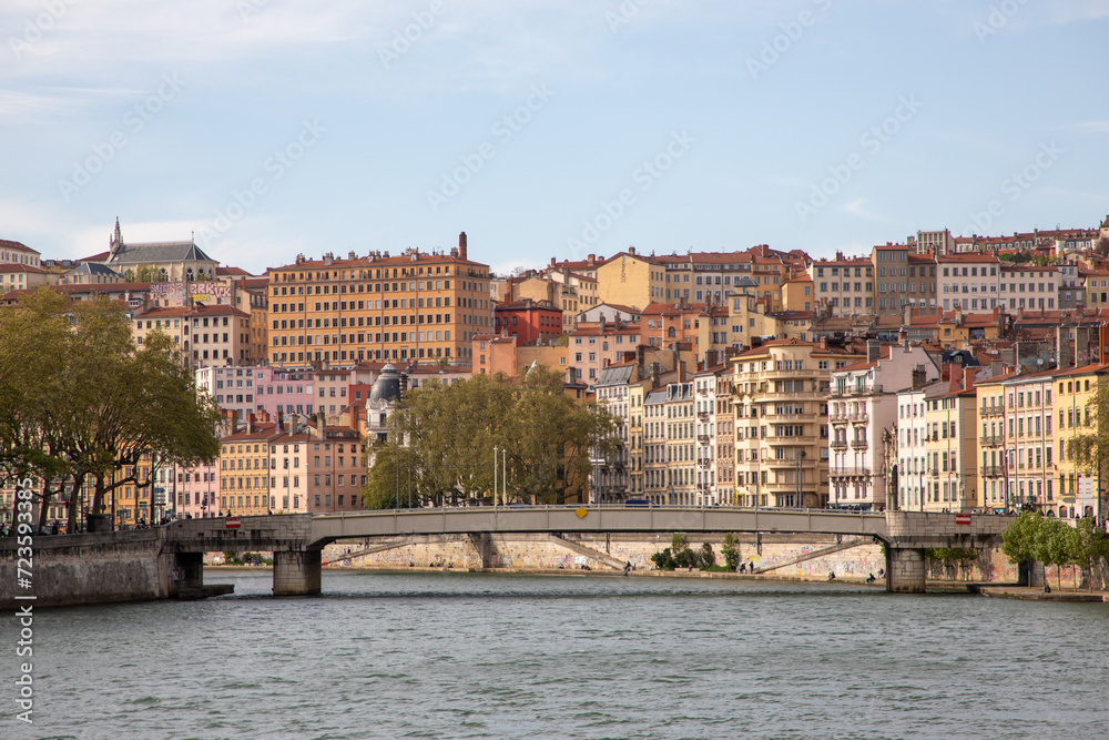 Lyon town colored houses facades with saone river and bridge in city in France