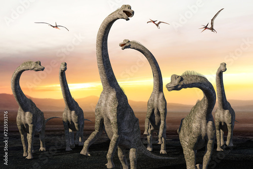 プテラノドンが飛び交う夕映えの大地を歩くブラキオサウルスの群れ © iARTS_stock