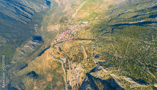 Delphi, Greece. Ruins of the ancient city of Delphi and the modern city. View of the valley. Sunny weather, Summer morning. Aerial view