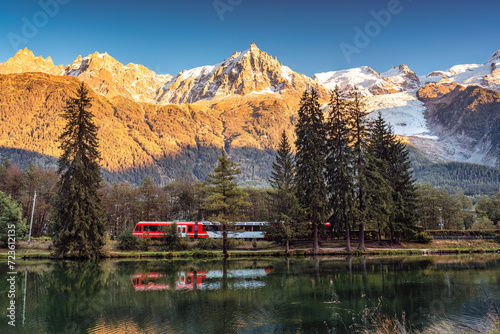 Lac des Gaillands with train passing and Mont Blanc massif reflection in the sunset at Chamonix, France