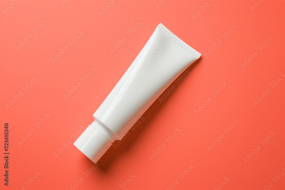 White colour cream tube on orange background. White colour cream tube on orange background.