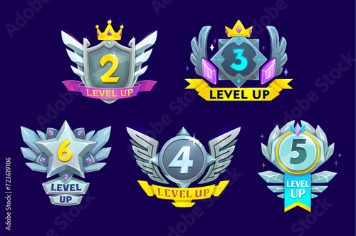 Game interface level up metal badges, steel win icons with wings and crystals, vector UI. Game level complete awards and rewards, silver shields, medals and prizes with rank stars, crowns and ribbons