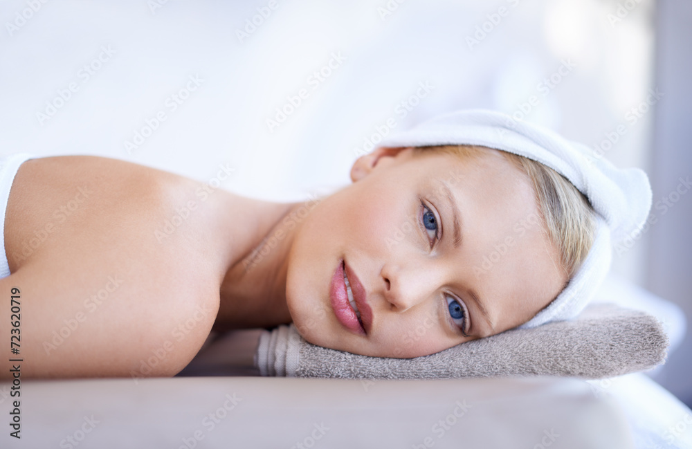 Portrait, woman and relax on table in spa for skincare, beauty and luxury treatment for wellness. People, rest and face of calm person on bed in hotel for massage or dermatology care for body