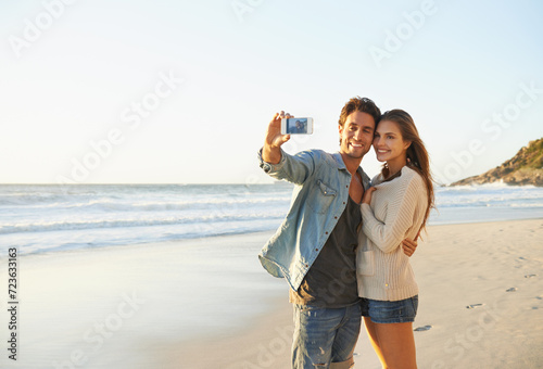 Couple, selfie and happy for hug by sea for memory on vacation with care, love and mock up space. Man, woman and smartphone for photography, profile picture and mobile app at beach on social media