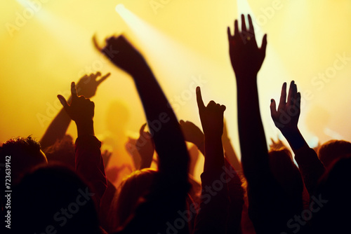 Festival, night dance and outdoor with audience at party and event in the dark with excitement and screaming. Freedom, social and people at concert with techno and music in an crowd with celebration