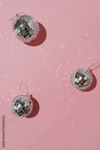 Shining disco balls with mirrored lights on pink background with blank copy space. Aesthetic holiday party event. Sparkling retro disco ball mockup template